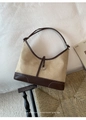 Detail of vintage suede hobo bag with contrast leather trim and silver metal hardware - Khaki