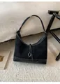 Close-up of minimalist black suede tote bag with contrast stitching and metal ring detail - Black