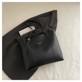 Detail of black leather tote bag with long handles and gold adjustable metal buckle - Black