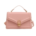 Chic pink PU leather square crossbody bag with gold oval lock and top handle on white background - Pink