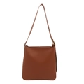 Minimalist brown leather tote bag with adjustable shoulder strap and metal eyelet details - Brown