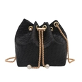 Elegant black woven bucket bag with gold chain strap and pearl accents in a stylish finish - Black