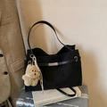 Retro black matte tote bag with silver buckle and bear charm on travel luggage - Black with Pendant