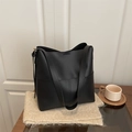 Minimalist black matte leather bucket shoulder bag with spacious design on soft fabric - Black