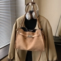 Camel suede tote bag with silver metal twist lock on a minimalist coat hanger display - Khaki Without Pendant