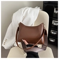 Detail of a brown tote bag with V-stitched pattern and ethnic woven shoulder strap - Tan