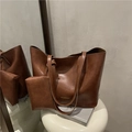 Vintage brown leather tote bag set with matching small pouch in a mirror reflection - Brown