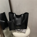 Black large-capacity leather tote bag set with small pouch on minimalist stand - Black