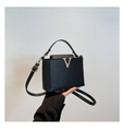Minimalist black leather bucket bag with gold V-shaped buckle and adjustable strap - Black