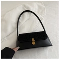 Detail of black faux leather handbag featuring a leopard print flap and golden metal clasp - Black