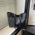 Minimalist black leather tote bag with elegant shoulder straps and fashion logo tag - Black