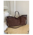Detailed close-up of dark brown matte suede tote bag on a stylish wooden stool - Coffee