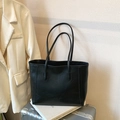 Large vintage black faux leather tote bag displayed on metal luggage with casual blazer - No Pendant / Black