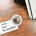 Macro view of a circular magnetic phone mirror stand with 'Gift For You' text on a desk - White (Magnetic Base-gift Mirror)