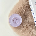 Macro shot of purple glitter button phone grip on a soft textured background - Pearl Purple