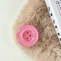 Close-up of pink glitter button phone grip on soft faux fur background texture - Pearlescent Rose Red
