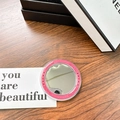 Close-up of a round pink portable makeup mirror with star patterns on a wooden surface - Rose Red (Magnetic Base-gift Mirror)