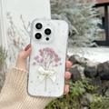 Detail of clear iPhone case with pink dried flowers, sequins, and a 3D silk bow - Real Flower Epoxy - Purple / iPhone 17 Pro Max