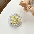 Detail showing a yellow resin cherry blossom phone socket with glitter and sequins - Magnetic Colorful Sequin Cherry Blossom No. 10