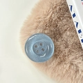 Close-up of a blue glitter button phone grip with four holes on a soft plush background - Pearl Silver Gray