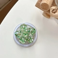 Close-up of a 3D floral phone socket with green sequins and a white collapsible base - Magnetic Colorful Sequin Cherry Blossom No. 11
