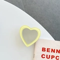 Close-up of a heart-shaped yellow phone grip and makeup mirror on a modern desk - Transparent Bracket-Jelly Edge Heart Mirror-Yellow
