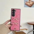 Detailed view of pink snakeskin leather texture with 3D bowknot on a folding phone case - Rose Red Bow Snakeskin Pattern
