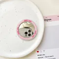 Close-up of a pink Good Luck magnetic mirror disc for Magsafe on a white ceramic plate - Pink