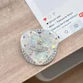 Detail of heart-shaped phone grip with iridescent surface and metallic orb logo - (White Diamond) Magnetic Shell Heart - #11 White Diamond Planet