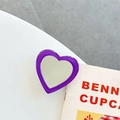 Detail shot of heart-shaped purple phone grip with mirror finish on magazine background - Transparent Bracket-Jelly Edge Heart Mirror-Dark Purple
