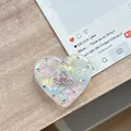 Nahaufnahme der herzförmigen Handyhalterung mit Strassrand und schillerndem Effekt - Transparenter Ständer - Muschelherz Planet - #12