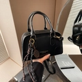 Black leather Boston bag with gold hardware and stylish rope pendant accessory - Black With Pendant