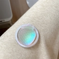 Macro shot of a 3D iridescent strawberry magnetic phone grip on a cozy beige knit texture - Iridescent Strawberry-White