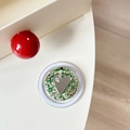 Detail of round phone socket with heart mirror and sparkling green glitter flakes - Magnetic Sequin Heart Mirror Style 11