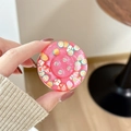 Close-up of a pink glitter phone grip with embedded miniature fruit slices and button holes - Fruit Pearl - Rose Red