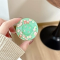 Close-up of mint green glitter phone socket featuring various colorful fruit slices - Fruit Pearl - Dark Green