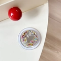 Macro detail of a round glitter phone socket with heart motif and 'mine' typography - Magnetic Sequin Heart Mirror Style 4