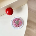 Close-up of heart mirror phone grip with pink and blue glitter sequins and brand logo - Magnetic Sequin Heart Mirror Style 9