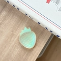 Macro detail of iridescent strawberry phone stand on light wood texture background - Iridescent White