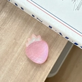 Detailed macro of a matte pink resin strawberry phone socket on a wooden desk setup - Holographic Pink
