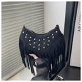 Detail of black suede crescent bag with gold studs and long fringe tassels - Black