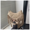 Detail of beige suede crescent bag with gold studs and long fringe tassels - Khaki