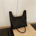 Minimalist black pebble leather tote bag with U-shaped opening and slender shoulder straps - Black