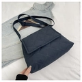 Detail of navy quilted crossbody bag featuring diamond stitching and adjustable strap - Navy Blue