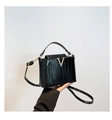 Chic black crocodile-textured bucket bag with shiny patent finish and gold V-buckle - Black