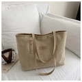 Detail of light khaki corduroy tote bag featuring leather strap and square logo patch - Khaki