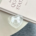 Detail of transparent heart phone grip with a pearlescent white bow on a desk - 3D Heart Stand - Bowknot Series - No. 9