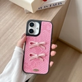 Close-up of pink snakeskin leather iPhone case with satin bows and gold metal accent - Large-hole Snakeskin Pattern - 2 Hand-tied Bows - Rose Red / iPhone 17 Pro Max