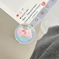 Detail of an iridescent round phone grip with a pink bow and sparkling rhinestone - Dreamy Bubble Crystal Ball Style (98)