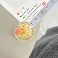 Close-up of a cute 3D yellow cartoon bear with heart inside a clear resin phone grip - Dreamy Bubble Crystal Ball Style (91)